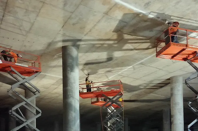 Angelus Waterproofing employees repair cracks in Silver Lake Resevoir's liquid storage area in los Angeles, CA